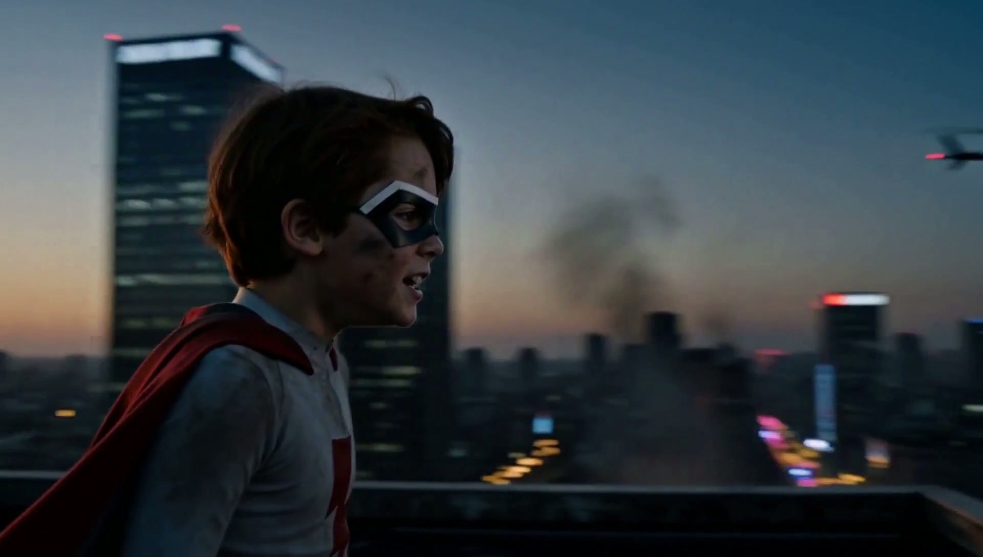 Frame from The Last Battle: the boy on a rooftop, the city behind him at first light
