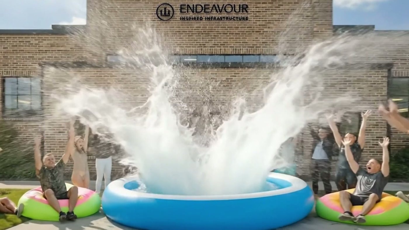 The bear lands in the pool